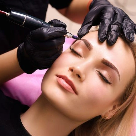 beautician is microblading young beautiful woman