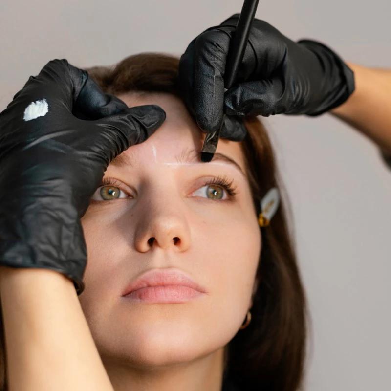 front-view-woman-getting-eyebrow-treatment-from-beautician